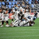 #26 Davy and #35 Ethan McCann-Carter stop the Brown running back Matt Childs who finished with 64 yards on 22 carries including two touch downs.