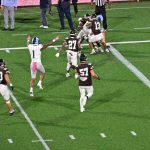 Another in the sequence showing Greg Gaines being held up as the ball fell to the turf.