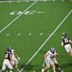 Brown QB James Murphy gets the edge and looks down field to pass or run.