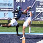 Strong safety #5 Jordan Campbell (Sacred Heart) puts his arm in between the ball and arm of the receiver.  Will it work?