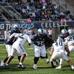 Number 75 Damon McMillan Jr. from Tampa, Fl leads opens the hole in the line against UNH