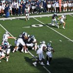 Back to game action, #8 AJ Pena and #56 Dontay Bishop (New Britain) pull the runner backwards.