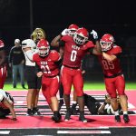 The defensive unit celebrates scoring two points on a safety in the Knight's endzone. The play followed a Vero kick off that started the Knights on their own 2 yard line.