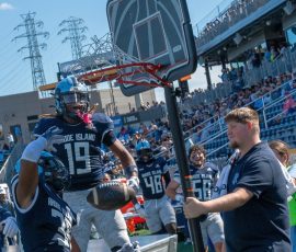 Rhode Island native Ethan McCan-Carter #19 punctuates his fourth quarter interception with a slam dunk celebration as teammates look on during the Rams' come-from-behind victory over Brown University in the Governor's Cup game.